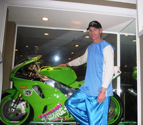 Scott Russell stand in front of his trophy case which houses his Muzzy Kawasaki that he won the World Superbike Championship on in 1993. (Larry Lawrence photo)