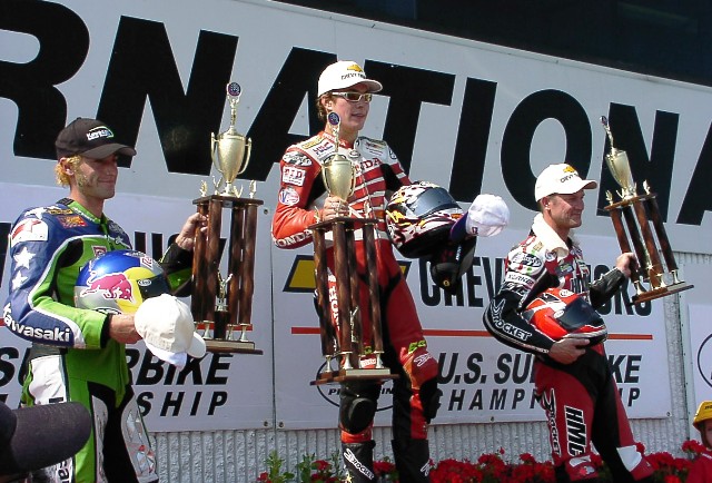 Brainerd SB podium 2002 Nicky Hayden stands atop the podium after winning the Brainerd (Minn.) round of the AMA Superbike Championship. He is flanked by Eric Bostrom, who finished second on the factory Kawasaki and third-place Doug Chandler, who rode the HMC Ducati. (Larry Lawrence photo)
