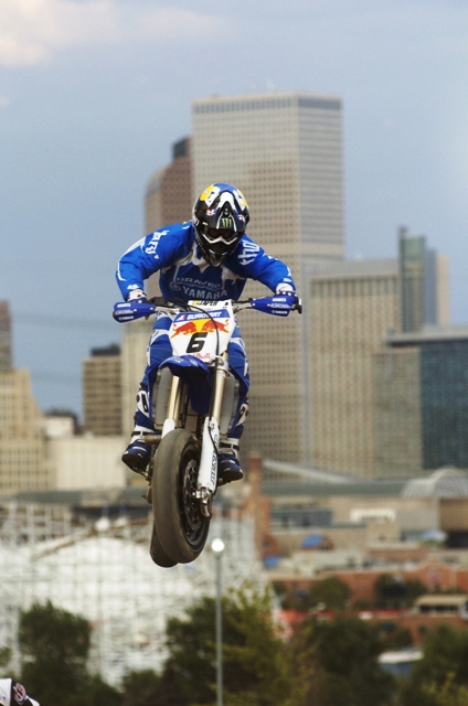 Burkhart - Denver-sm Mark Burkhart jumps his Graves Motorsports Yamaha Supermoto bike into the air with the Denver skyline in the background at an Aug., 2006 AMA Supermoto race at Mile High Stadium on the near Westside of downtown Denver. (Larry Lawrence photo)