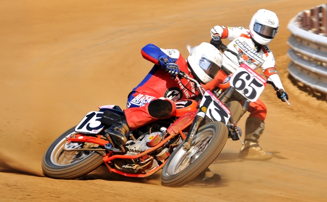 During practice for the 2009 Indy Mile Daniel Gedeon shows the classic steering with the throttle technique broad-sliding his No. 13 KK/Lucas Oil/American Harley-Davidson in front of Lancaster Harley-Davidson’s Cory Texter (65).  (Larry Lawrence photo)