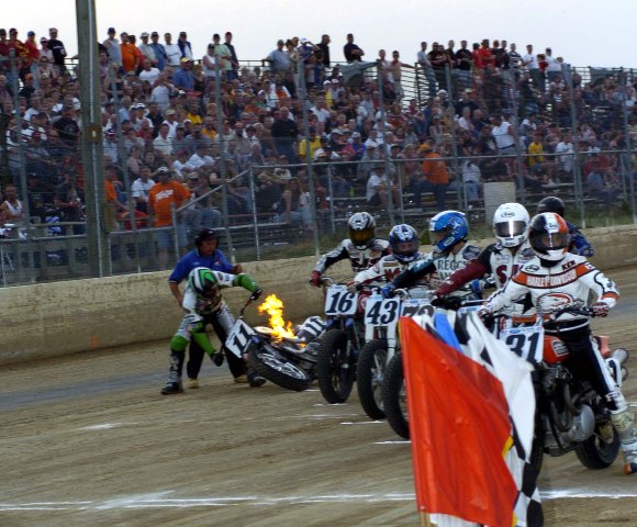 Hot bike-sm Bryan Bigelow's motorcycle catches fire at the start of a Heat race during an AMA Grand National at I-96 Speedway in July 2006. (Larry Lawrence photo)