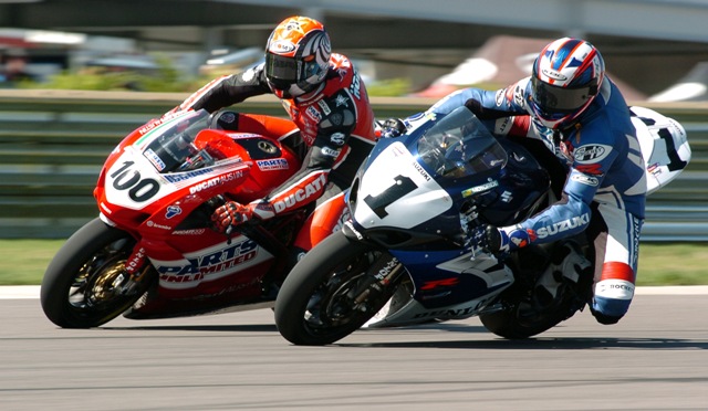 Mladin-Hodgson 001 Mat Mladin, on the Yoshimura Suzuki dives on the inside of Ducati rider Neil Hodgson to take the lead in the AMA Superbike Sunday race at Barber Motorsports Park in 2005. (Larry Lawrence photo)