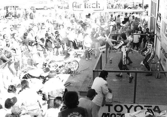 Willow F-USA podium Robbie Petersen, Rich Oliver and Chuck Graves spray champagne from the podium after the Willow Springs round of the WERA Formula USA race in 1991. (Larry Lawrence photo)