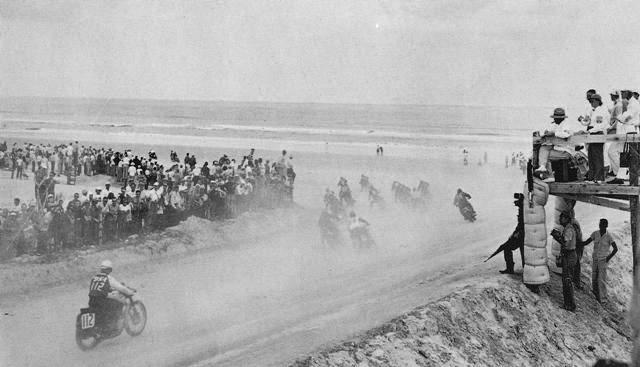 The south turn of the old Daytona Beach course during the 1952 Daytona 200. BSA ace Chuck Basney (112) can clearly be seen entering the turn. 