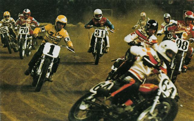 Houston '75 Gary Scott (64) leads eventual winner Kenny Roberts (1), Mert Lawwill (behind Scott in the black helmet), John Hateley (98), Ron Powell (31E), Mark Williams (70) and a rookie named Jay Springsteen (65X) in the 1975 Houston TT National. (AMA Press Kit Photo)