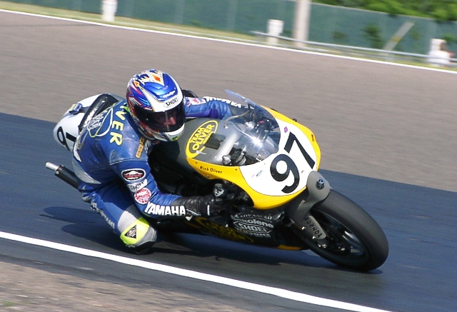 Oliver, Rich - 2002 Rich Oliver leans his Yamaha into a turn at Brainerd in 2003 en route to his final of three undefeated seasons. He previously went undefeated in 1996 and 1997. (Larry Lawrence photo)