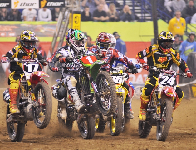Pourcel - Indy 2010 Christophe Pourcel wheelies his Monster Energy/Pro Circuit Kawasaki off the starting gate in the Lites East race in Indianapolis. He held this wheelie all the way to the first turn. Also charging towards the turn is Justin Barcia (17), Troy Adams (65) and Brett Metcalfe (24). (Larry Lawrence photo)