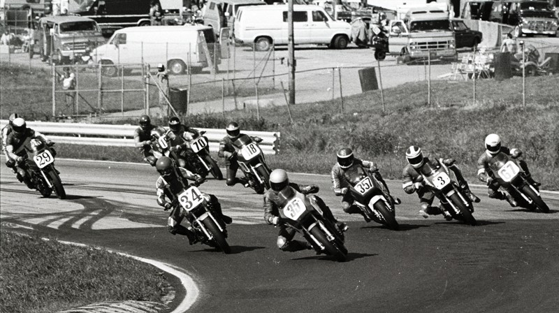 The start of the 1985 WERA C Production Final at Road Atlanta. I’m not 100 percent sure on all these riders, but I think we have Neil Barker (35) leading into turn one with Ed Key (34) taking the inside line. Andre Vandenberg (357), Bart Peterson (3) and Greg Tysor (67) are railing around the outside. Following are Jeff James (118), Tom Malaska (70) and Tim Wilson (29). (Larry Lawrence photo)