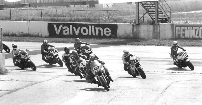 Mike Pearcy (567) leads the way over Ed Key (1), eventual winner Brian Berney (56), Tim Morrissey (854), Steve Campisano (123), Steve Holmes (48) and Chuck McCabe (486) in a WERA B Production race at Mid-America Raceway in 1984. (Larry Lawrence photo)
