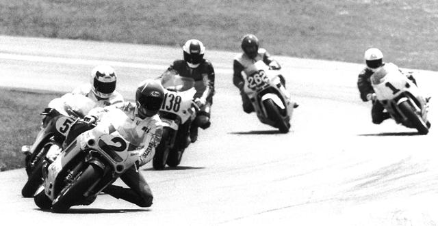Smith - Grattan Team Suzuki Endurance rider Mike Smith leads Fritz Kling on the 3 Guys Racing Suzuki (behind Smith), 3-D Racing’s Mark McDaniel (138), Andy Fenwick on the defending championship winning Human Race Team Yamaha (1) and an unidentified rider on bike No. 282 during a 1989 WERA National Endurance Eight Hour at Grattan Raceway. (Larry Lawrence photo)