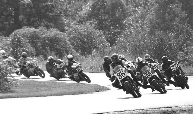 Allan Zahrt (86) nails the holeshot and gets through turn one first in a WERA B Production race at Blackhawk Farms sometime in the mid-1980s. Zahrt is leading a great group of riders that includes Doug Gere (551), Michael Schultz (367), Ken Davis (in the Arai Cooley Replica helmet behind Schultz), Brian French (718), Ned Hart (224) and Toni Sharpless (239). (Larry Lawrence photo) 