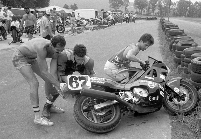 Tysor scrub Greg Tysor shows off his unique method of scrubbing in his race tires and the serious muscle definition in his arms. The poor guys helping Greg are the ones eating all the dust. (Larry Lawrence photo)
