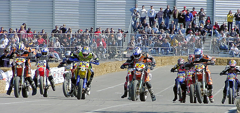 Cols. SuMo start 03 - paintshop It was an international field that took to the track in downtown Columbus during an AMA Supermoto heat race on October 5, 2003. It looks like Australian Mark Avard (94) is getting the jump, but right there with him on the front row are American’s Ben Carlson (45) and Chris Fillmore (11) and Jurgen Kunzel (52) of Germany. (Larry Lawrence photo)