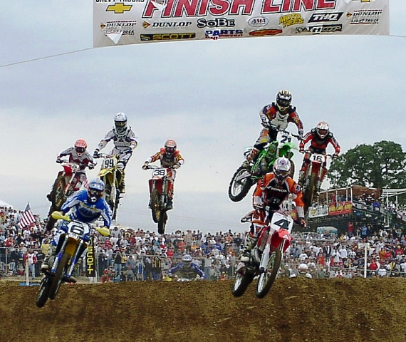 Hangtown 2002 - 250MX start Steve Lamson (6) and Ricky Carmichael (4) lead the pack early in 250cc Moto 1 at the Hangtown National in 2002. Stephane Roncada (21), Sean Hamblin (99), Keith Johnson (38) and John Dowd (16) and Jeremias Isreal (89) give chase to Lamson and Carmichael. Carmichael went on to win the moto and the overall. (Larry Lawrence photo)