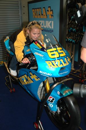 Myers Rizla 1 Elena Myers tries Loris Capirossi's MotoGP racebike on for size in a paddock garage at Mazda Raceway Laguna Seca.