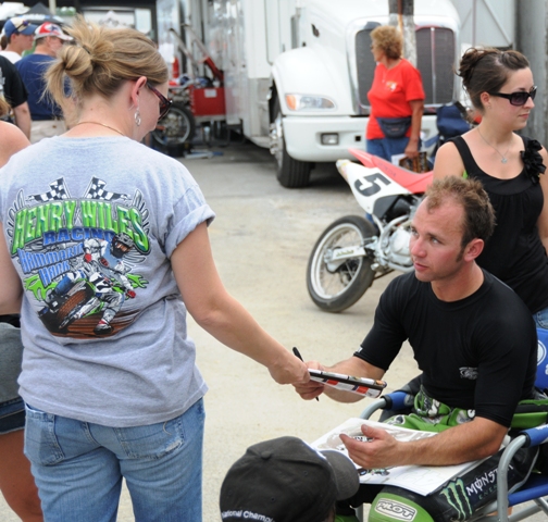 Smith, Bryan Monster Energy Kawasaki rider Bryan Smith looks to be trying to decide to whether or not to give an autograph to a fan who was wearing a Henry Wiles t-shirt of all things at the Lima National. It was a tough call, but Bryan was the bigger man and came through with the autograph in the end. (Larry Lawrence photo)
