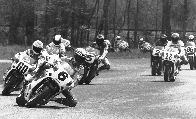 Smith - Talladega Mike Smith leads a group of some of the best road racers of the early 1990s, during a WERA A Superstock race at Talladega Grand Prix Raceway. Smith (6) leads his Team Hammer teammate Kurt Hall (6), Mike Harth (65), Bruce Baldus (5), another Hammer member Britt Turkington (28) and Tripp Nobles (2) early in the race. (Larry Lawrence photo)