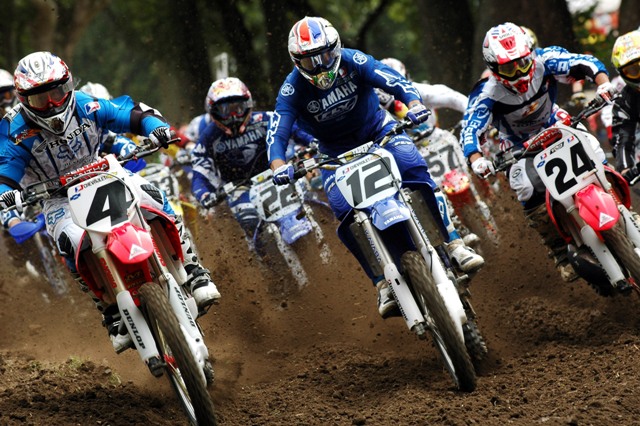 Ricky Carmichael (4) nails the holeshot and leads David Vuillemin (12) and Ernesto Fonseca (24) at the start of the second moto at the Troy (Ohio) National at Kenworthy’s Motocross Park on July 25, 2004. (Larry Lawrence photo)