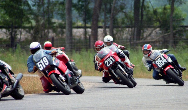 Clemmer, Jim - Talladega June 1986 Jim Clemmer, riding his No. 519 Kawasaki Ninja 600, heads a pack that included Ronald Earl, No. 231 Suzuki GSXR750, and Kenny Anderson on his No. 854 Yamaha FZ750 in a WERA B Production Novice race at Talladega Grand Prix Raceway in June of 1986. Clemmer had his best weekend of the ’86 season at Talladega that day scoring podium finishes in three classes that day. (Larry Lawrence photo)