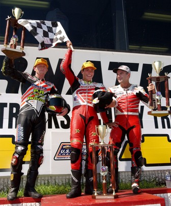 Brainerd SB 2001 podium Nicky Hayden (center), of Owensboro, Ky., celebrates his AMA Superbike victory Sunday at Brainerd (Minn.) Int’l. Raceway. He is joined on the podium by second-place Kurtis Roberts (left), of Modesto, Calif., and Canadian Miguel Duhamel (right) who finished third, making it a Honda sweep of the top-three positions. It was the second-straight AMA Superbike win of the year for Hayden, who moved to third in the series standings. (Brian J. Nelson photo)