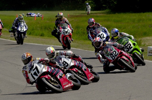 Duhamel - BIR 2001 Canadian Miguel Duhamel (17) leads eventual winner Nicky Hayden (69), of Owensboro, Ky., and the rest of the pack through Brainerd Int’l. Raceway’s Turn Nine on the first lap of the AMA Superbike race in 2001 in Brainerd, Minn. Series leaders Mat Mladin, of Australia, crashed in Turn Eight and can be seen in the background looking at his downed Suzuki. (Brian J. Nelson photo).