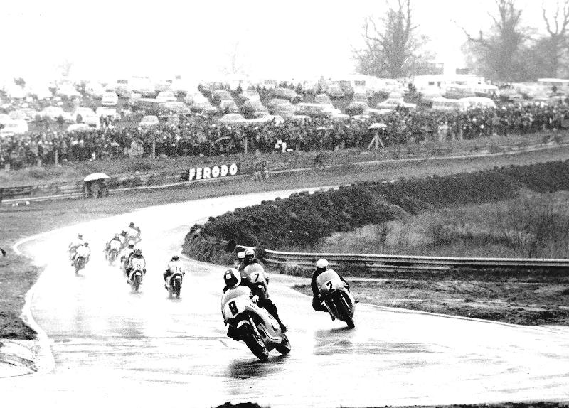 Aldana - Oulton Park 1975 David Aldana heads the pack as they splash their way around Oulton Park in the 1975 Transatlantic Match Races. Aldana leads American teammates Kenny Roberts (2) and Pat Hennen (7). Brits Mick Grant (14) and Barry Ditchburn (15) can be seen heading up the second group of riders. (Jim Greening photo)
