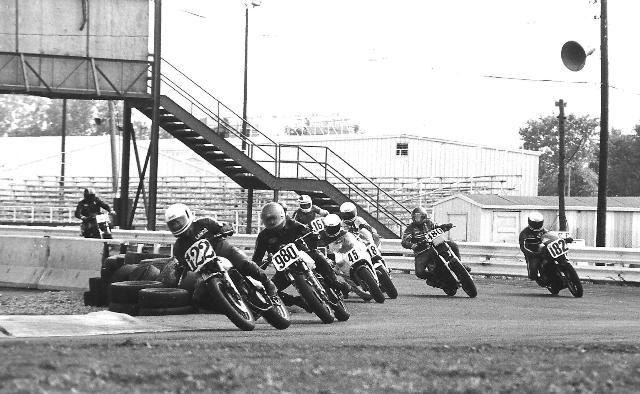 David, Lance - St. Louis Lance David (122) leads Doug McIntosh (980), Frank Brotz (45), Brain French (718), Greg Comstock (480), Larry Sutherby (182), Gary Brennan (168) and Bob Tapscott, the first novice rapidly moving up from the second wave in a WERA E Superbike race at Gateway International in 1985. (Larry Lawrence photo)