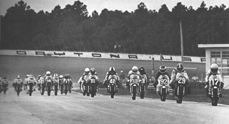 Daytona 250GP '82 Pole winner Jimmy Filice (17) leads the field coming into the International Horseshoe at the start of the 1982 Daytona International Lightweight Road Race. Behind Filice are Sam McDonald (29), Craig Morris (92), Martin Wimmer ((318), Fred Merkel (3), Rich Schlachter (48) and Tony Head (315). Other riders visible in the shot are David Emde (10), Donny Greene (20), Antonio Neto (346), Bruce Maus (158) and Hugh Humble (4). (Courtesy DIS)