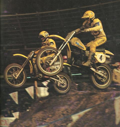 Kent Howerton, on the No. 4 factory Suzuki, races Rick Burgett on his factory Yamaha, battle side by side during a circa 1980 AMA Supercross race. (AMA press kit photo)