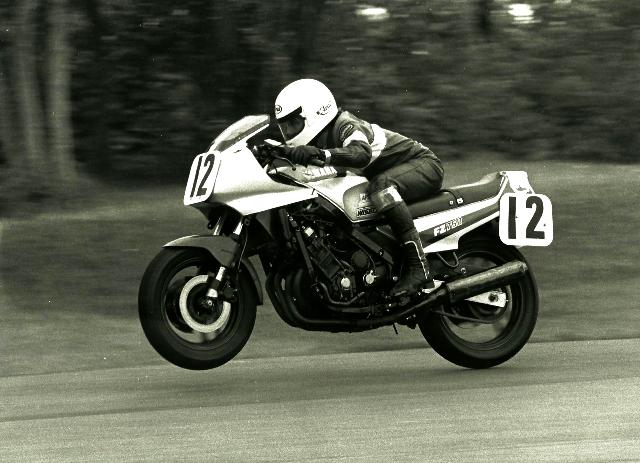 Johnston, Ralph - Grattan 1986 Ralph Johnston wheelies his Yamaha FZ750 over the jump at Grattan during a WERA sprint race there in 1986. Johnston was one of the leading WERA B Production riders of the mid-1980s, when Yamaha paid generous contingency money in the class. In this race Johnston scored a podium finish, taking second behind Suzuki GSXR750 rider Mark Tanner. (Larry Lawrence photo)