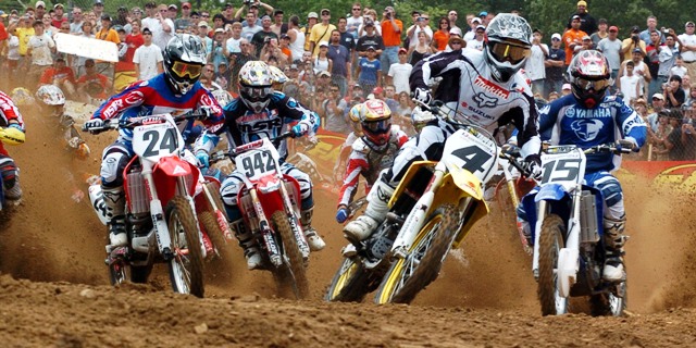 Carmichael M1 start Budds Creek 2005 Ricky Carmichael (4) gets his usual excellent start in the first moto at the AMA 250cc Motocross National at Budds Creek on June 19, 2005. Chasing RC in this photo are Ernesto Fonseca (24), Juss Laansoo (942) and Tim Ferry (15) among others. (Larry Lawrence photo)