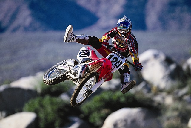 Ryan Hughes takes a jump for the camera in this 2001 Honda press kit photo. The thing that strikes me about this photo is the giant boulders in the background. (Honda press kit photo)