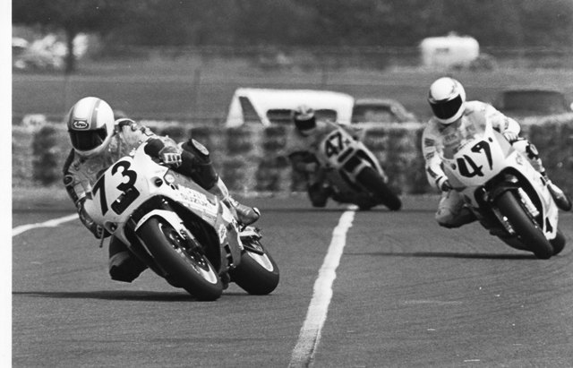 Gray - Memphis F-USA 1990 Scott Gray leads Rick Kirk and Tommy Sloan in a WERA Formula USA National at Memphis Motorsports Park in 1990. Kirk, who was riding a Human Race Team Yamaha, crashed big at turn eight, the bike blasting through the hay bales, hitting a concrete barrier wall and careening back into the racing line. Kirk was not seriously injured and blamed oil leaking from Gray’s bike for the crash. (Larry Lawrence photo)