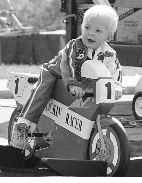Rockin' Racer I’m not 100 percent sure, but I think this is Taylor Knapp as a toddler playing on a toy called the Rockin’ Racer during a WERA race weekend at Grattan Raceway sometime in the late 1980s. The Rockin’ Racer was the only road racing related toy I can remember from that era. If this is Taylor you can see that he was getting an early start in becoming a racer. He even has his own set of leathers. (Larry Lawrence photo)