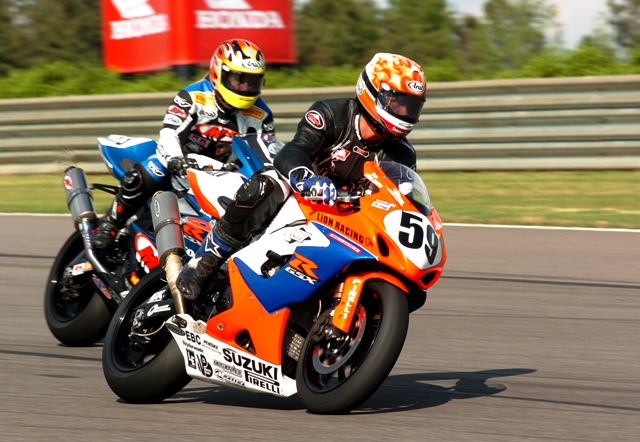 Holden - Haskovec - Barber '05 Jake Holden on the No. 59 Lion Racing Suzuki enters a corner leading Vincent Haskovec on the No. 33 M4 EMGO Suzuki during the Saturday AMA Superbike race at Barber Motorsports Park in April of 2005. Holden dropped out after 11 laps and was credited with 35th out of 41 starters. Haskovec went on to finish ninth, just behind Eric Bostrom and just ahead of Marty Craggill. (Larry Lawrence photo)