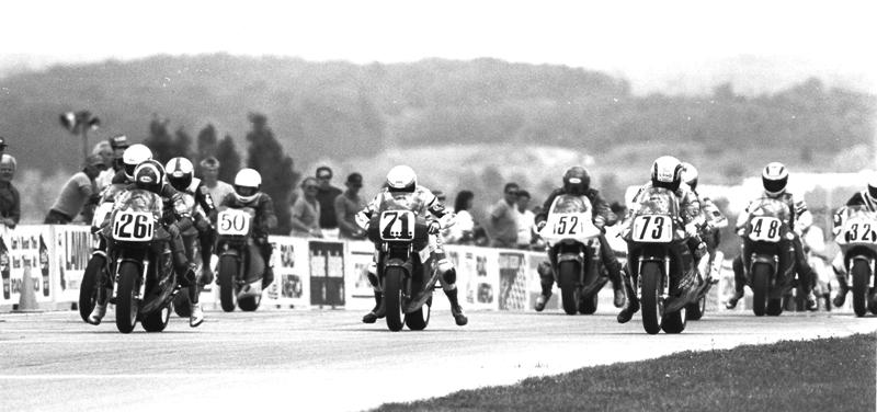 Jimmy Adamo on the No. 26 Team Leoni Ducati gets the jump on Kevin Erion’s No. 71 Two Brothers Racing Honda and Ferracci Ducati’s Jamie James on the No. 73 bike. James went on to win this race and the championship. Also pictured in the photo are Ely Schless (No. 50), Randy Shemwell (No. 52) and Dale Quarterley (32). I’m not certain who No. 48 is – perhaps local Brian French. (Larry Lawrence photo)
