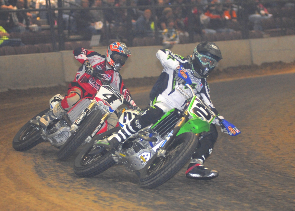 Coolbeth v Carr Kenny Coolbeth (No. 2 Chaplin Kawasaki) and Chris Carr (No. 4 American Motorcyclist Association/DFW Honda) battle late in the Du Quoin Short Track National. Coolbeth took the victory. Carr finished second. This dark and smoky arena was very difficult to photograph. (Larry Lawrence photo)