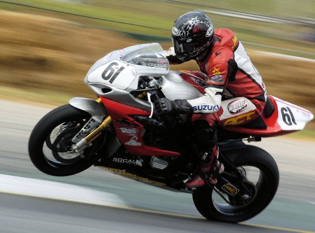 Jensen, Scott - Atl SB 2007 Scott Jensen wheelies his Halof Racing Suzuki Superbike out of a turn at Road Atlanta during the AMA Superbike race there in September of 2007. Jensen scored an 11th-place finish in the Saturday race at Road Atlanta, which matched his best Superbike result of the year. Jensen went on to finish 12th in the final standings that season. (Larry Lawrence photo)