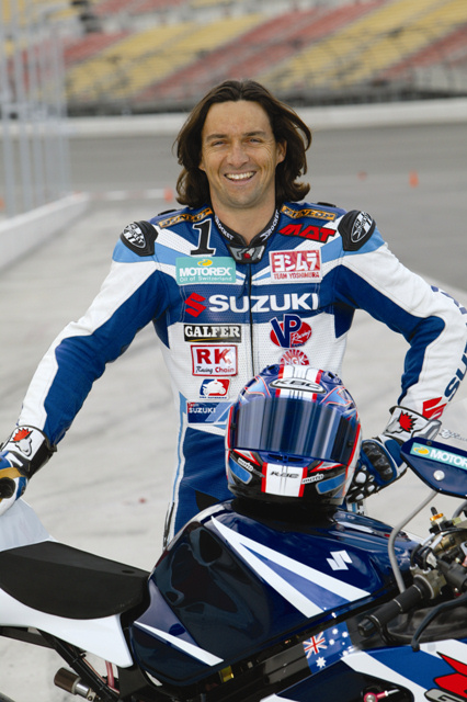 Mladin 2004 Mat Mladin going through a long-hair stage in 2004 in a Yoshimura Suzuki press kit photo.