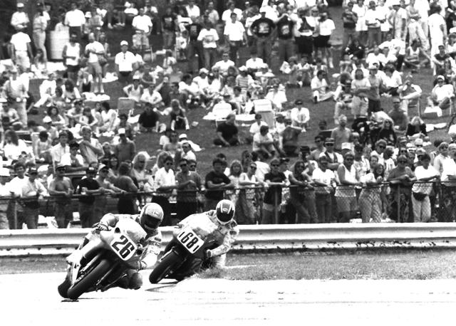 Adamo - Picotte - Elkhart Jimmy Adamo leads Pascal Picotte in the AMA Pro Twins race at Road America in June of 1991. Picotte took the lead on the last lap to edge out Adamo for the victory. Note the big crowd on the hill outside of turn five. (Larry Lawrence photo)