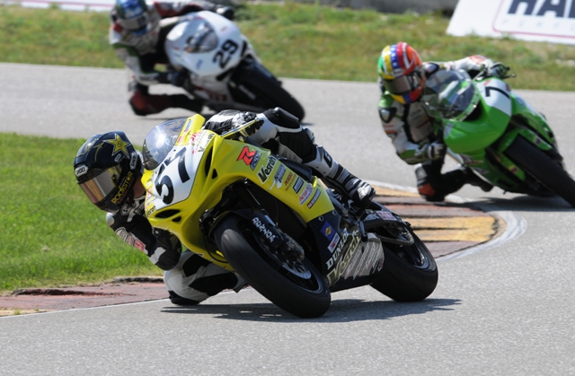 West, Cory - Sun morn Elk Vesrah Suzuki's Cory West shows his extreme lean-off style as he leads Fernando Amantini (7) and Barrett Long (29) through the turn 11 chicane in the back section of Road America during practice on Sunday morning. (Larry Lawrence photo)