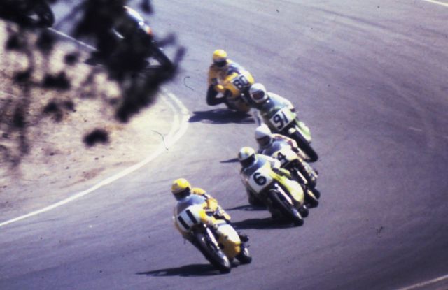 Larry 1_026 Don Castro leading a pack that includes Gary Scott (No. 64) on a Triumph, Hurley Wilvert on a factory-backed Kawasaki and Kenny Roberts (then simply known as Ken Roberts) heading down the corkscrew at Laguna Seca in 1973. (Alan Sessarego photo)