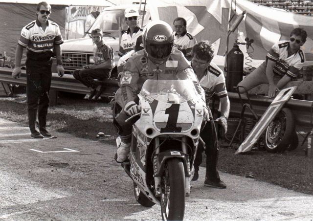 Smith - Valvoline pit_024 Mike Smith and his Valvoline Suzuki get a push out of the pits from Keith Perry at Indianapolis Raceway Park during a WERA National Endurance race sometime in the early 1990s. (Larry Lawrence photo)
