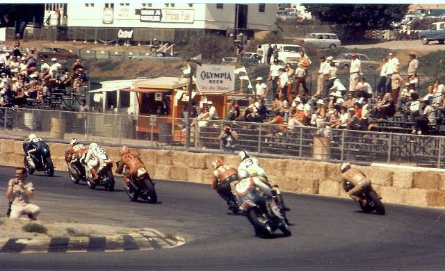 Laguna '73 - sm From the AMA Road Race National at Laguna Seca - this looks like the final turn and it shows Ron Grant (No. 61) leading this pack that includes Don Emde (No. 25), Keith Mashburn (No. 19), Rex Beauchamp (No. 31), Gene Romero (No. 3), Ray Hempstead (No. 99), John Skinner (No. 66) and Eddie Mulder (No. 12). (Alan Sessarego photo)