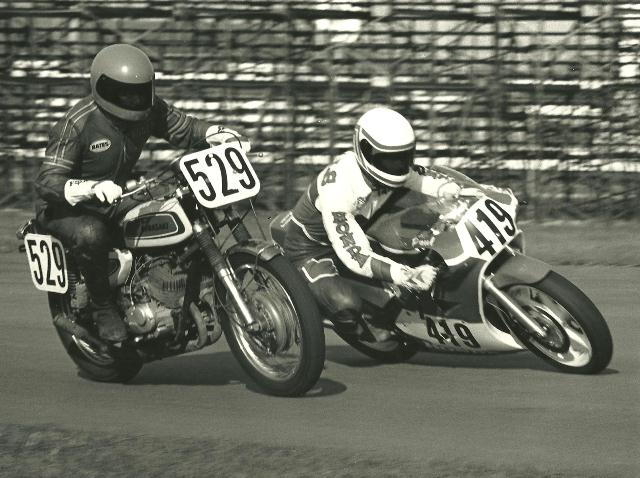 Mills - Swartout Paul Mills (No. 419) on what would have been at the time a state-of-the-art 250 Grand Prix racer, a Honda RS250, trying an outside pass on the vintage (maybe an early ‘70s S1?) Kawasaki of Roger Swartout (529) in a WERA race at Indianapolis Raceway Park. (Larry Lawrence photo)