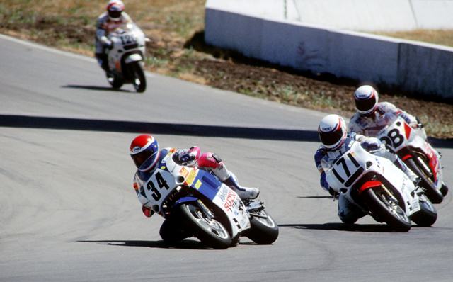 Cooley - Topeka-sm Two-time AMA Superbike champion Wes Cooley, riding the Valvoline Suzuki, leads a pack of riders in the WERA Formula USA race at Heartland Park Topeka in July of 1990. Behind Cooley is Joe Pittman (No. 171), John Hopperstad (No. 98)and Chuck Graves (No. 120). (Larry Lawrence photo)