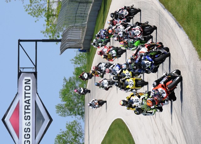 The entire Daytona SportBike field, with Jason DiSalvo leading the way, speeds its way into Turn Three at Elkhart Lake’s Road America. Capturing the entire field in a single photo is one of the biggest challenges in motorsports photography. (Larry Lawrence photo)