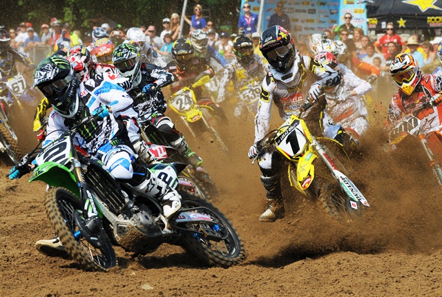Monster Energy Kawasaki’s Ryan Villopoto (No. 2) nailed the holeshot in the second 450 moto at Millville, Minnesota this past summer. While Villopoto has the first turn dialed, it appears that his archrival Ryan Dungey seems to have the front end crossed up on his No. 1 Rockstar/Makita Suzuki. (Larry Lawrence photo)