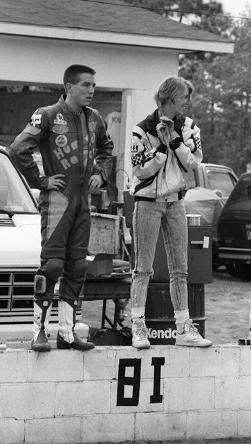 Human Race Team rider Andy Fenwick (left) stands on the pit wall waiting to see teammate Paul Bray come down the front straightaway at Roebling Road during a WERA National Endurance race in March of 1990. (Larry Lawrence photo)