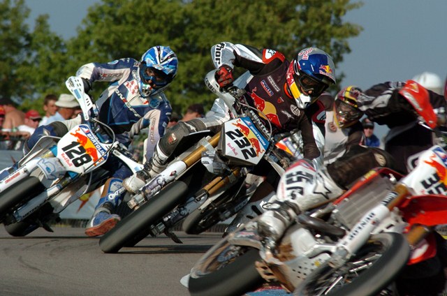 Eric Bostrom, racing a KTM 450SMR, is in the pack battling Honda-mounted Andrea Bartolini at the AMA Supermoto race at USA International Raceway  in Shawano, Wisconsin, on July 30, 2005. E Boz turned in a respectable performance scoring ninth. Bartolini, the 1999 FIM World 500cc Motocross Champion from Italy, got past Bostrom in this race to finish eighth. (Larry Lawrence photo)